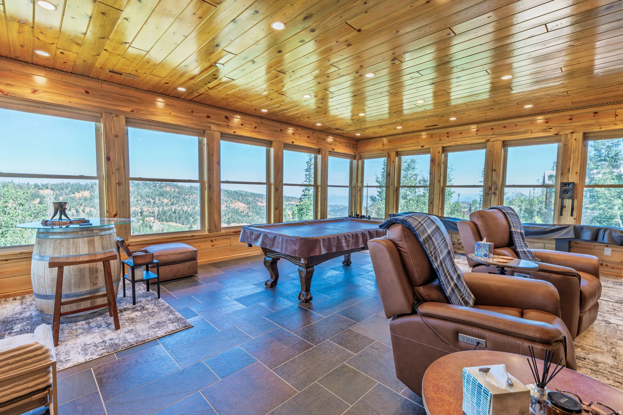 Room featuring extensive wood paneling, recessed lighting, and large picture windows