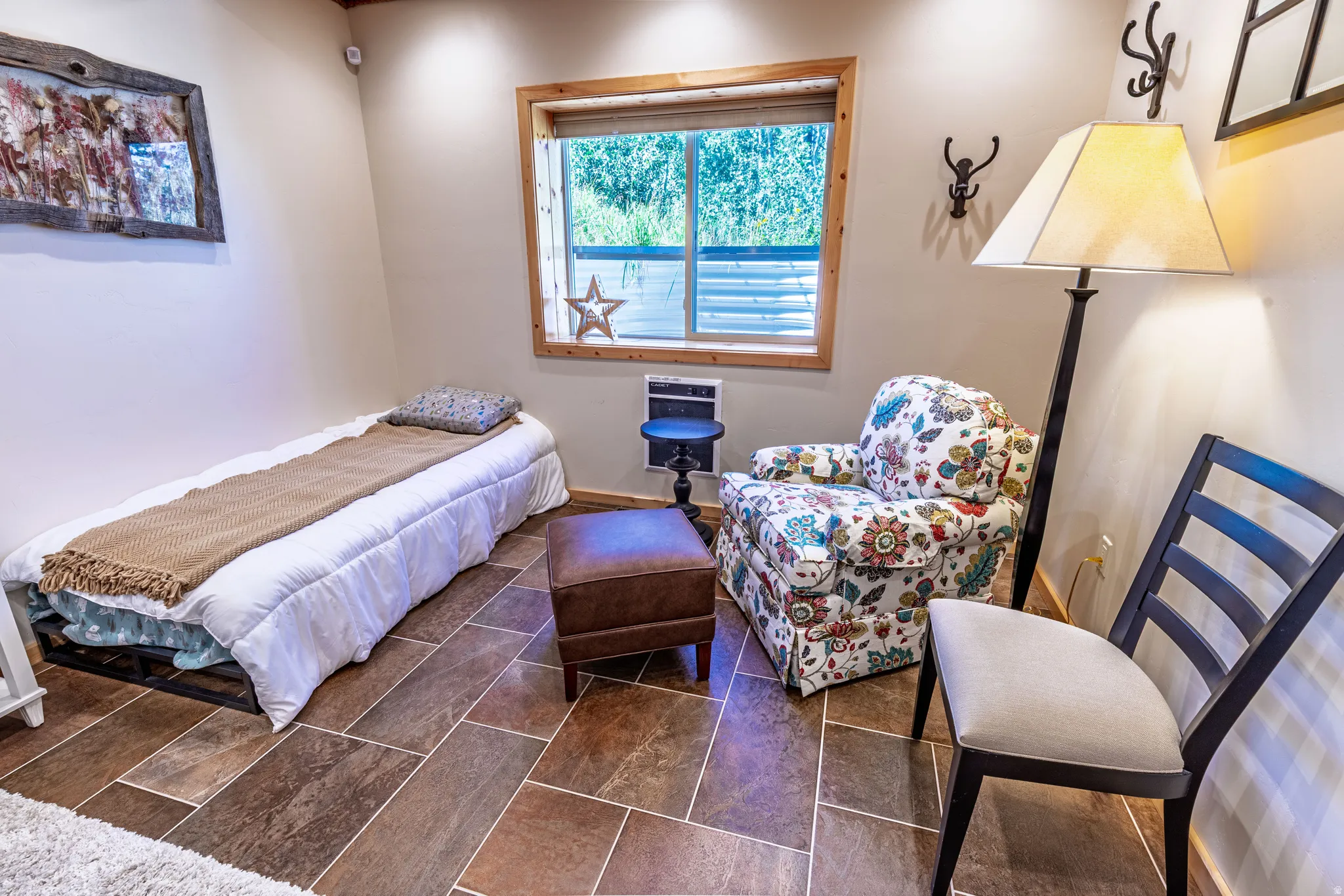 Rectangular tile flooring, a window with wood trim, and recessed ceiling lighting