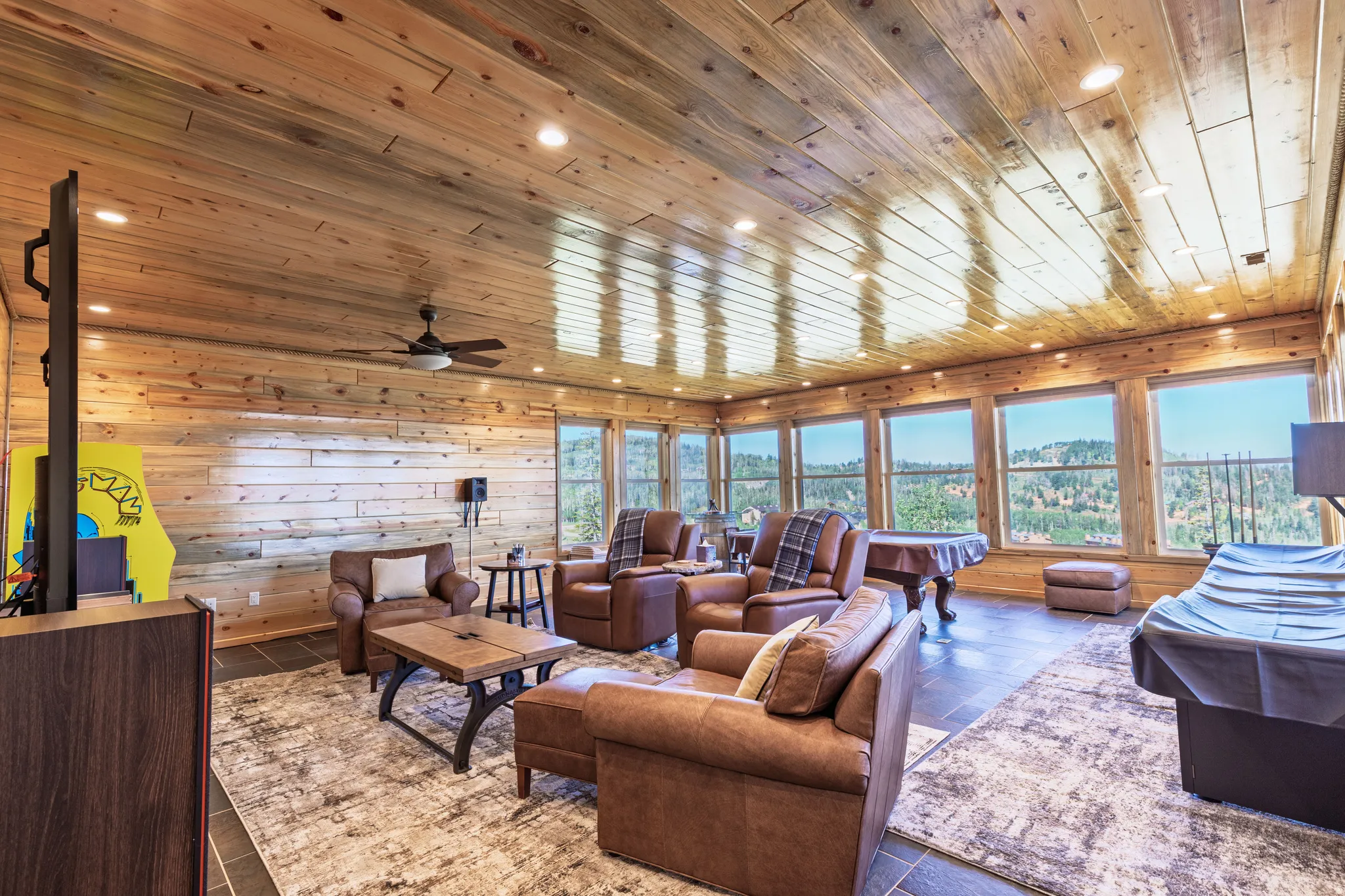 Wood-paneled walls and ceiling with recessed lighting