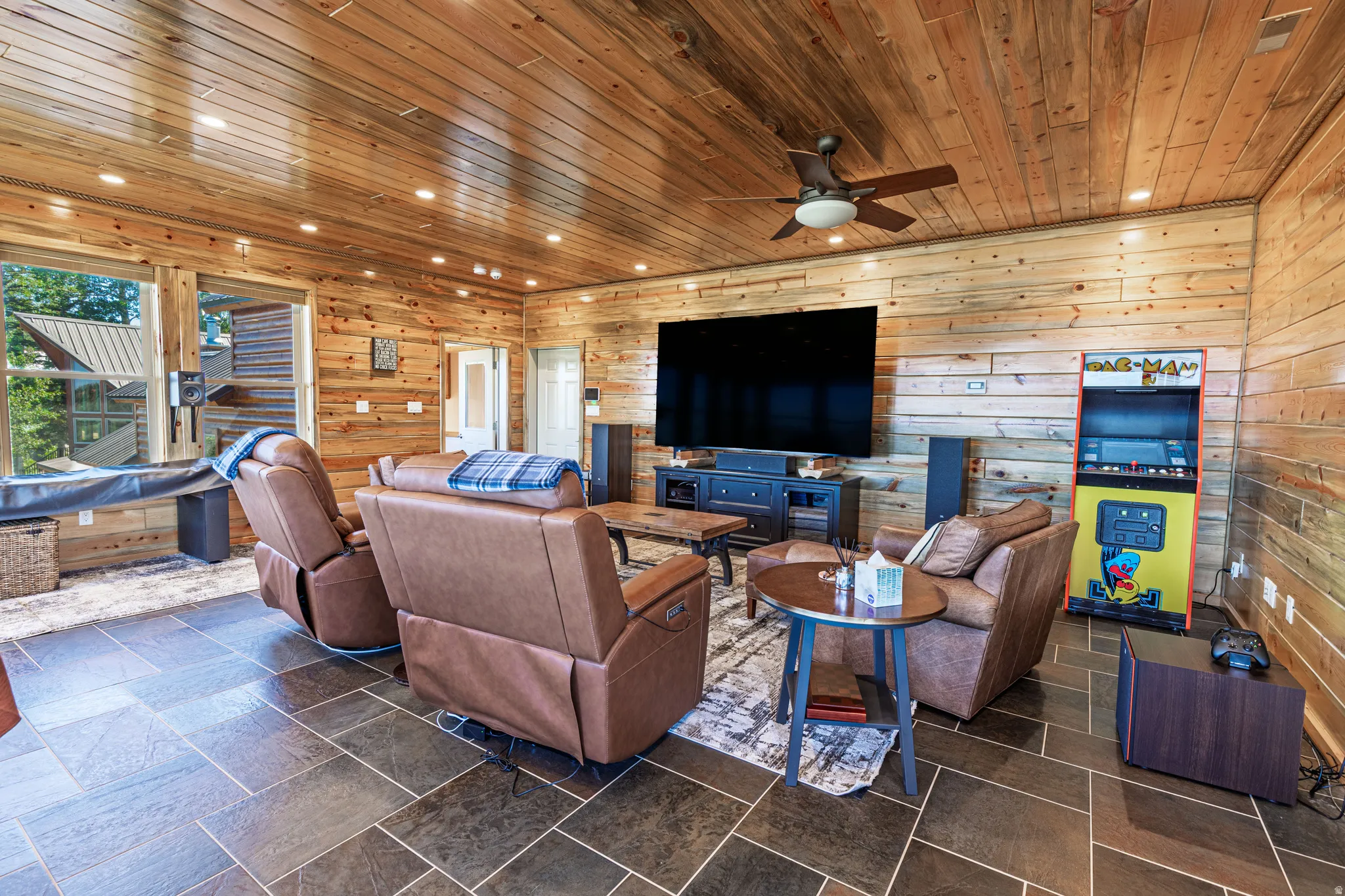 Wood-paneled walls and ceiling with recessed lighting