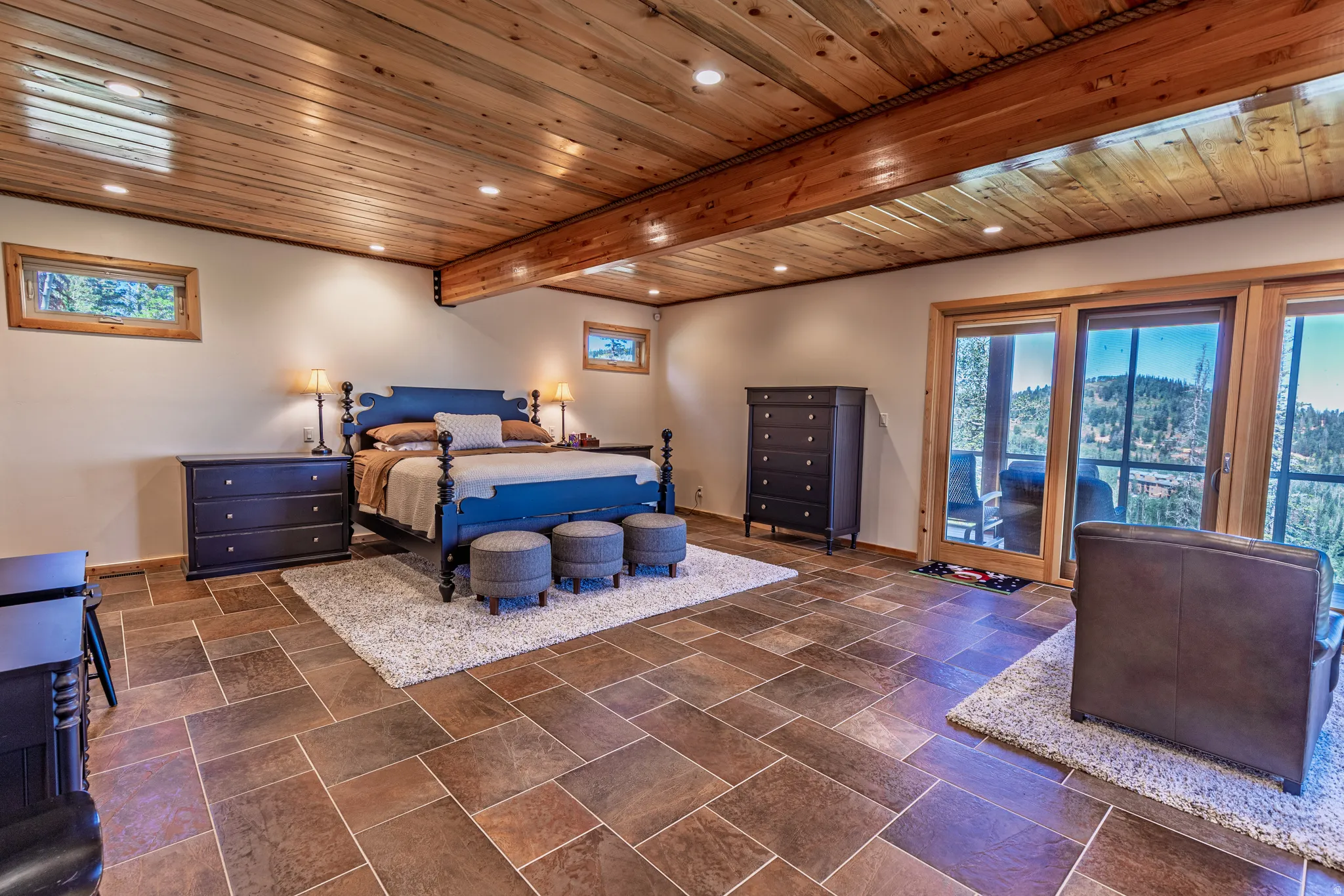 Wood-panel ceiling with recessed lighting and exposed wood beams