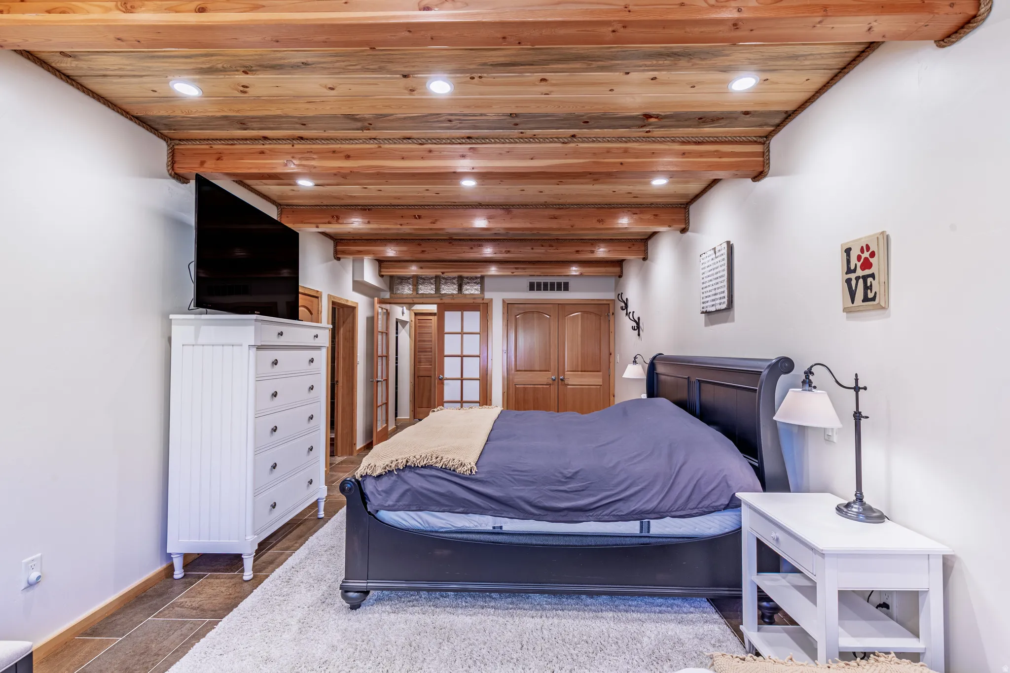 Wood-beamed ceiling with recessed lighting