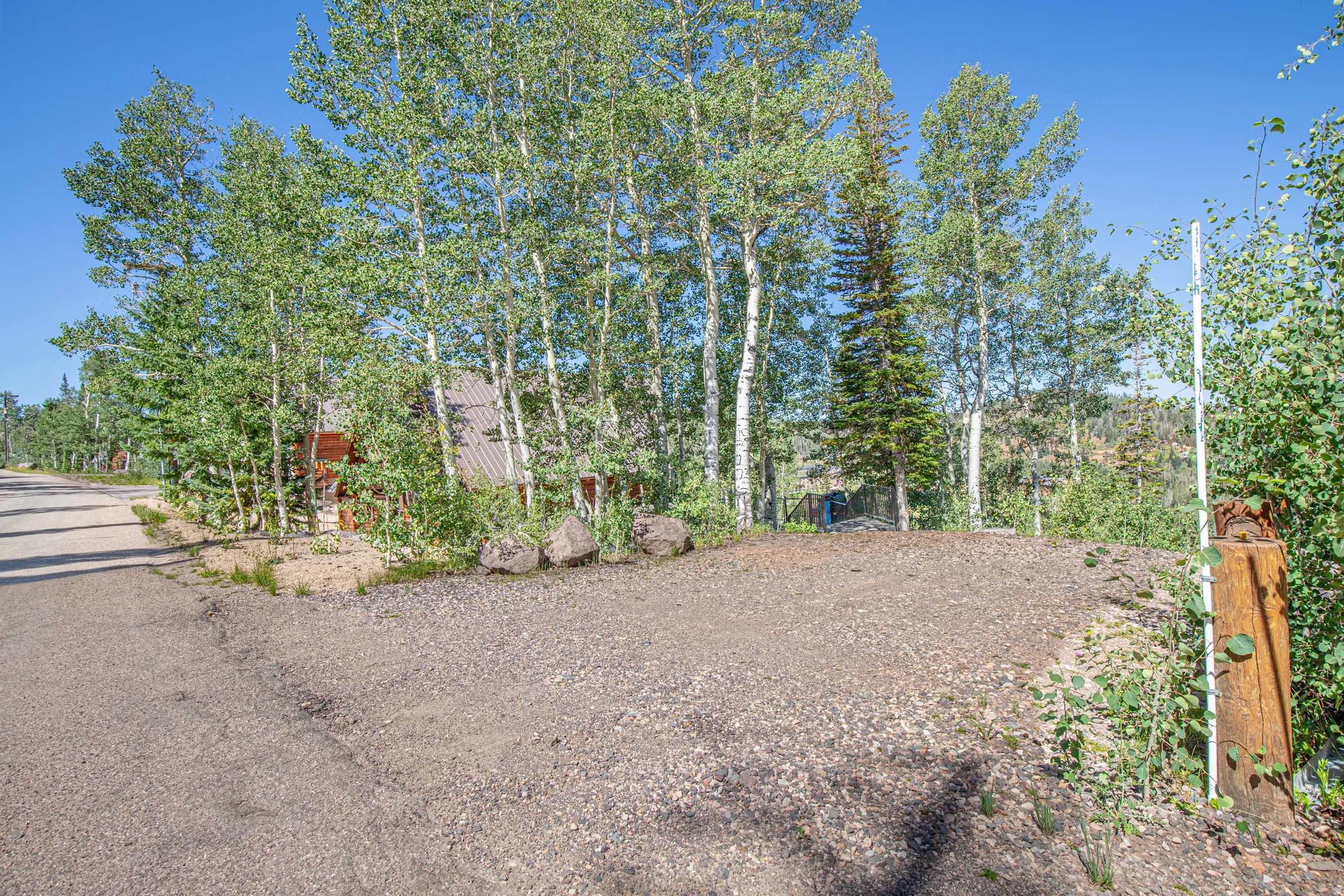 Gravel driveway bordered by natural rock landscaping