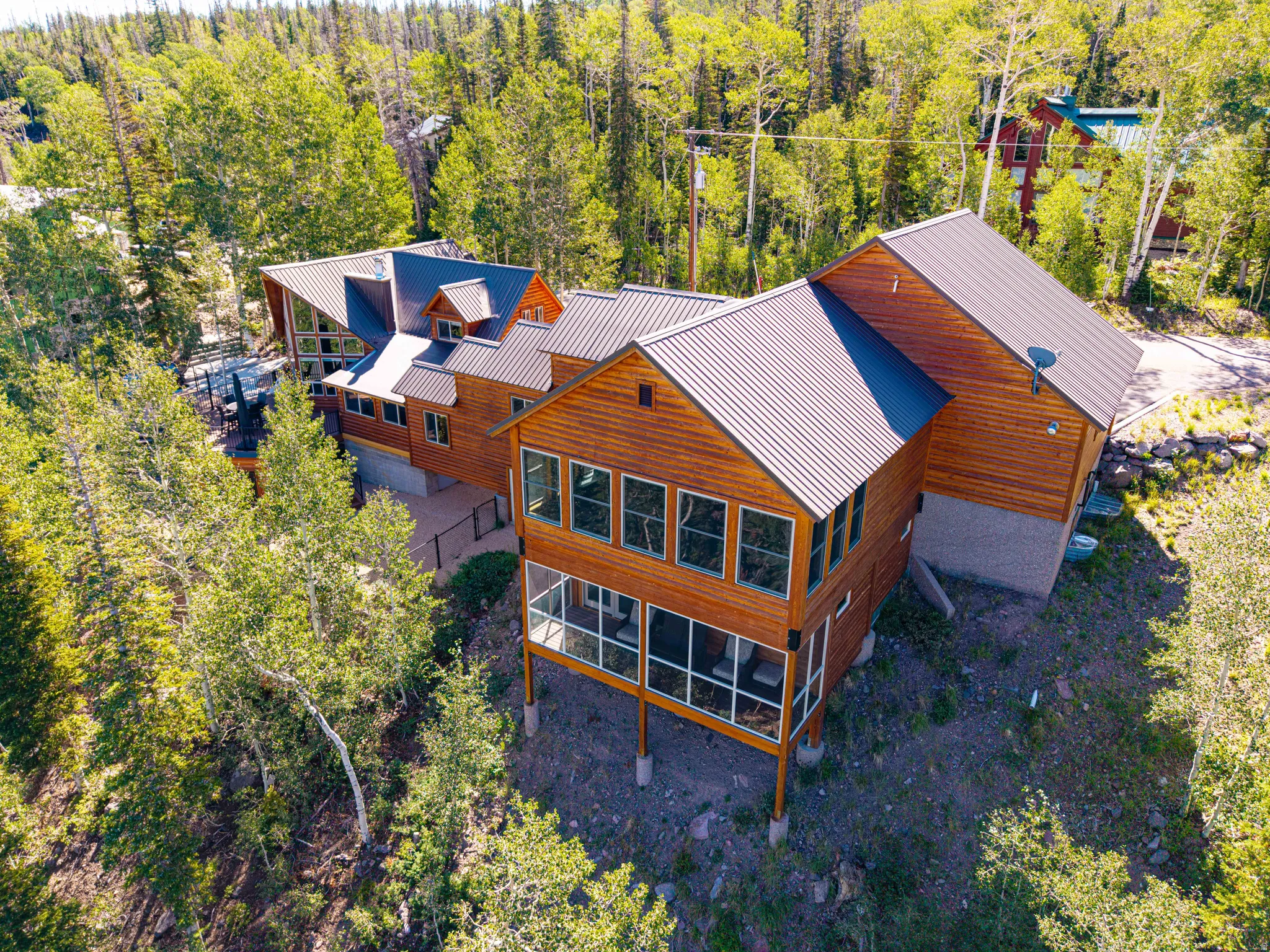 Multi-level residence featuring wood siding and a metal roof