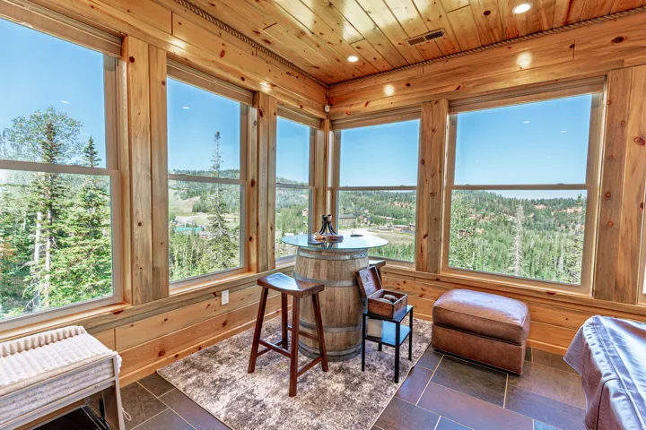 Expansive room with large windows, wood paneling, wood plank ceiling, recessed lighting, and tile flooring