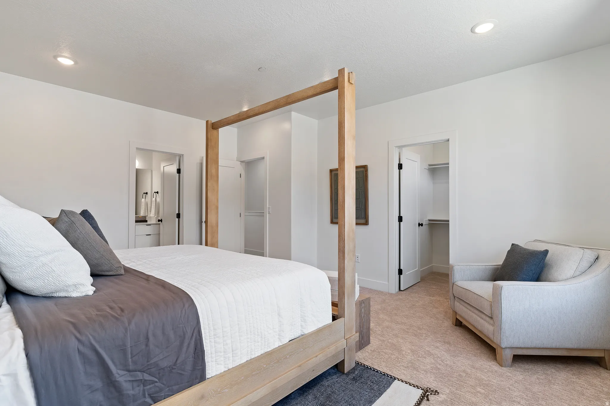 Recessed lighting, carpeted flooring, and a walk-in closet with built-in shelving