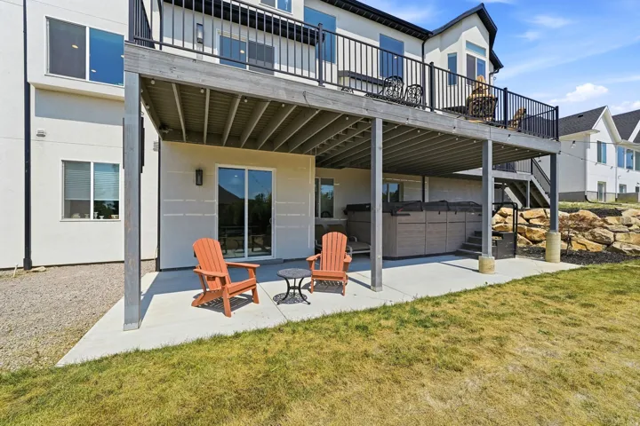 Lower-level patio with concrete surfacing and an integrated spa