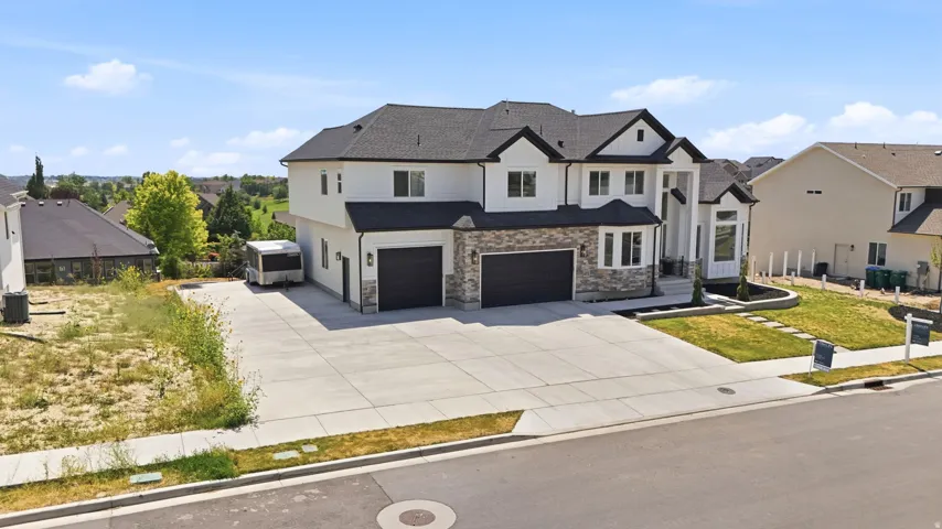 Two-story residence featuring white siding and dark roofing