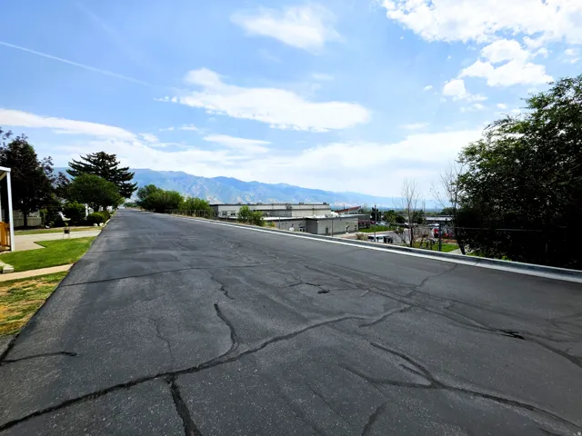 Front road with mountain backdrop and clear sky views.