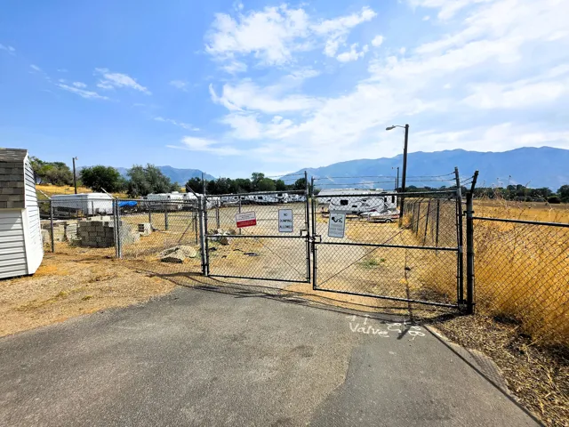 On property RV secure storage with distant mountain scenery.