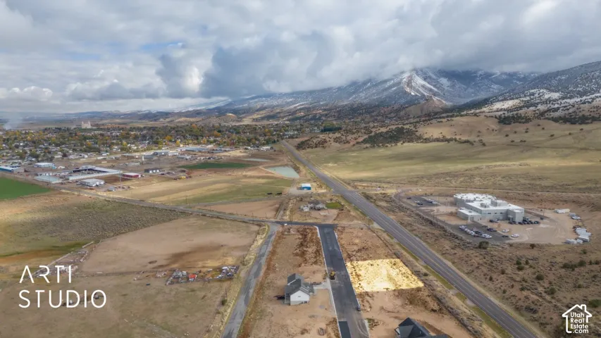 Expansive lot with adjacent paved roadway and distant mountain range