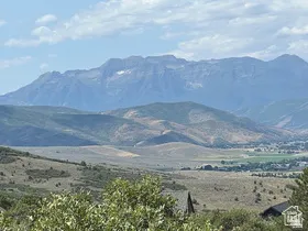 Expansive mountain range, distant valley, and natural landscape
