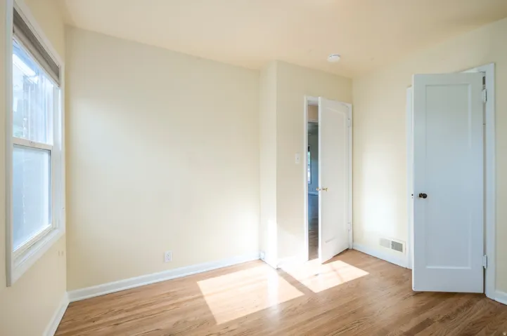 Wood-finish flooring, white trim, and light-colored walls