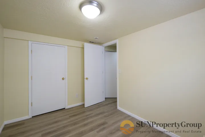 Wood-finish flooring, flush mount lighting, and neutral wall tones