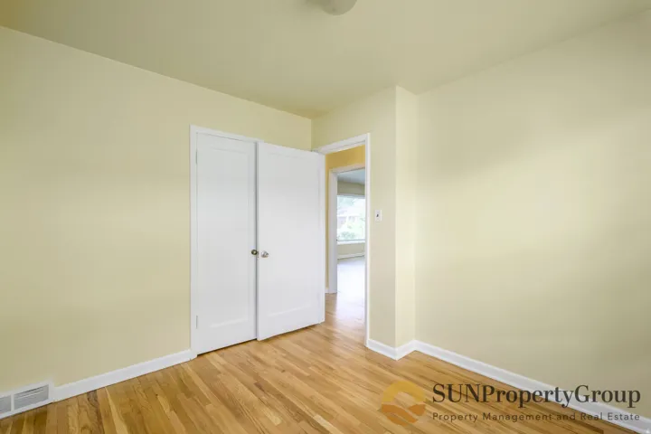 Hardwood flooring, painted walls, and white trim