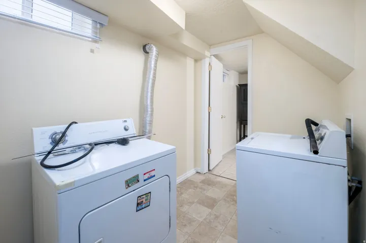 Vinyl flooring, white walls, and a window with blinds