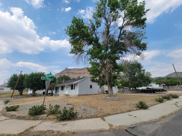 Corner lot with mature trees and a distant mountain backdrop