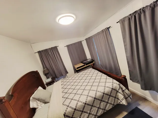 Recessed lighting, light wood-finish flooring, and white walls