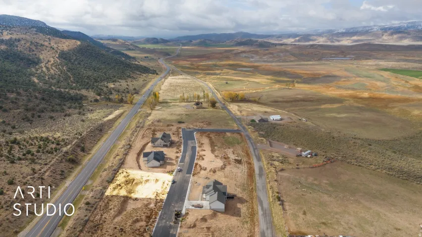 New construction homes with paved road access, situated near a highway, with natural terrain surrounding