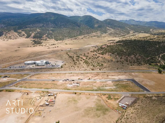 Expansive undeveloped land with mountain backdrop, surrounded by natural terrain