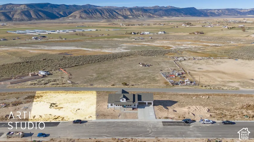 Expansive undeveloped lot with street frontage and distant mountain range backdrop