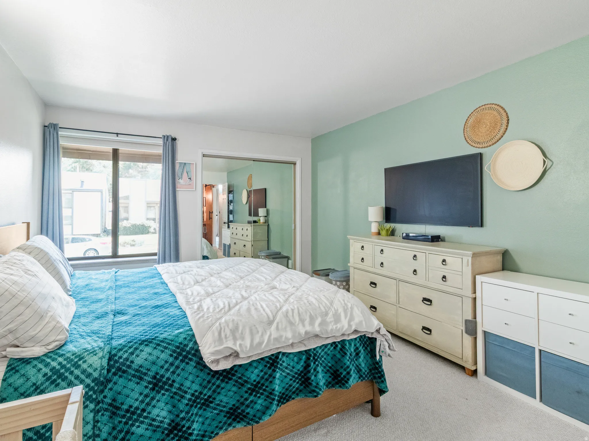 Wall-mounted television with substantial window featuring dark trim