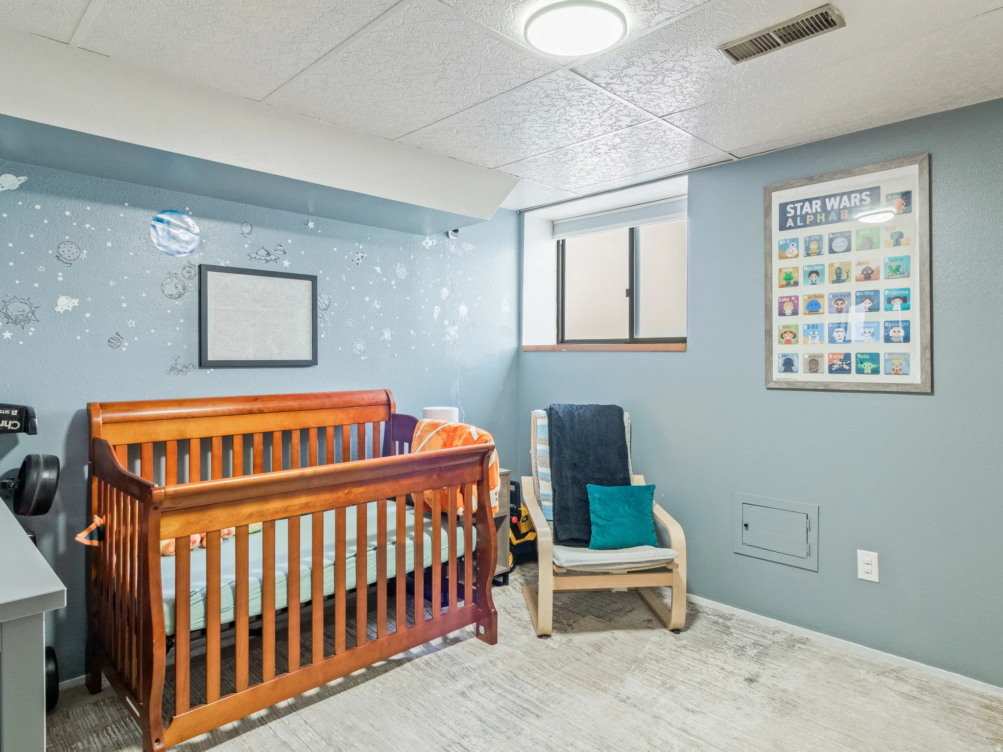 Recessed window with wood trim, light blue wall paint, drop ceiling, and flush-mount ceiling light