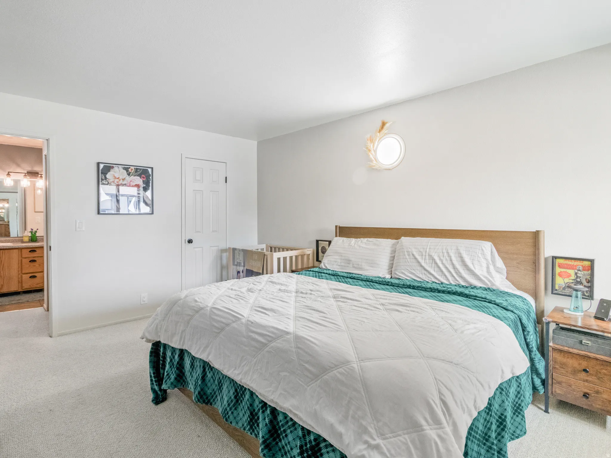 Recessed ceiling lighting, light-toned carpeting, white walls, and a two-panel interior door with dark hardware