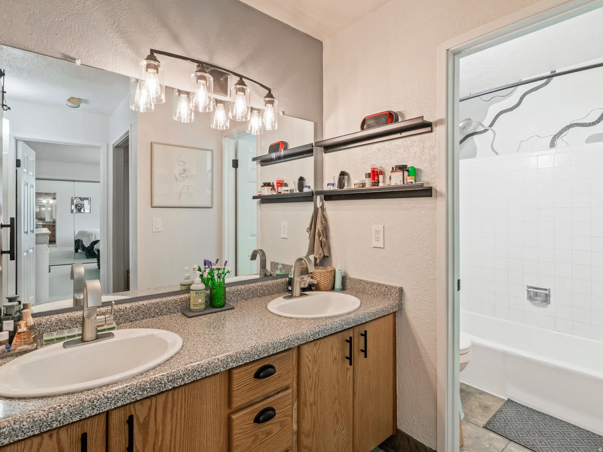 Dual vanity with wood-finish cabinetry and silver-toned hardware