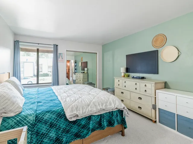 Wall-mounted television with substantial window featuring dark trim