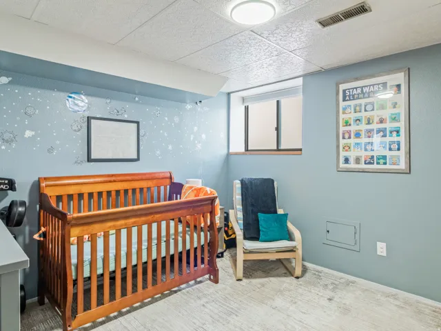 Recessed window with wood trim, light blue wall paint, drop ceiling, and flush-mount ceiling light
