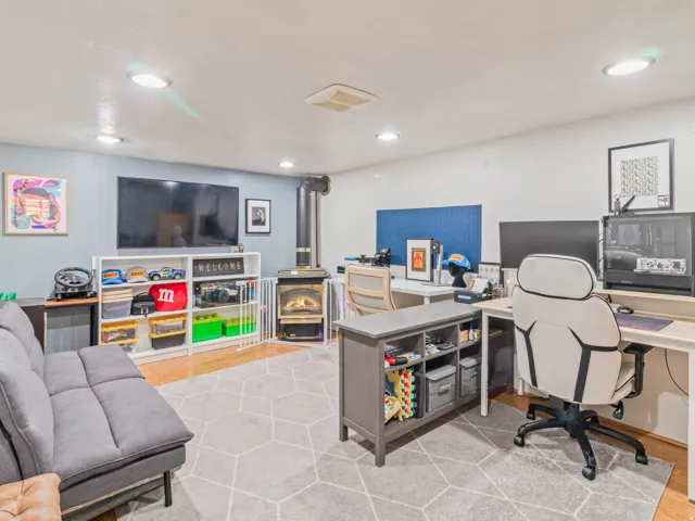 Recessed lighting, wood-finish flooring, wood-burning stove, and built-in shelving