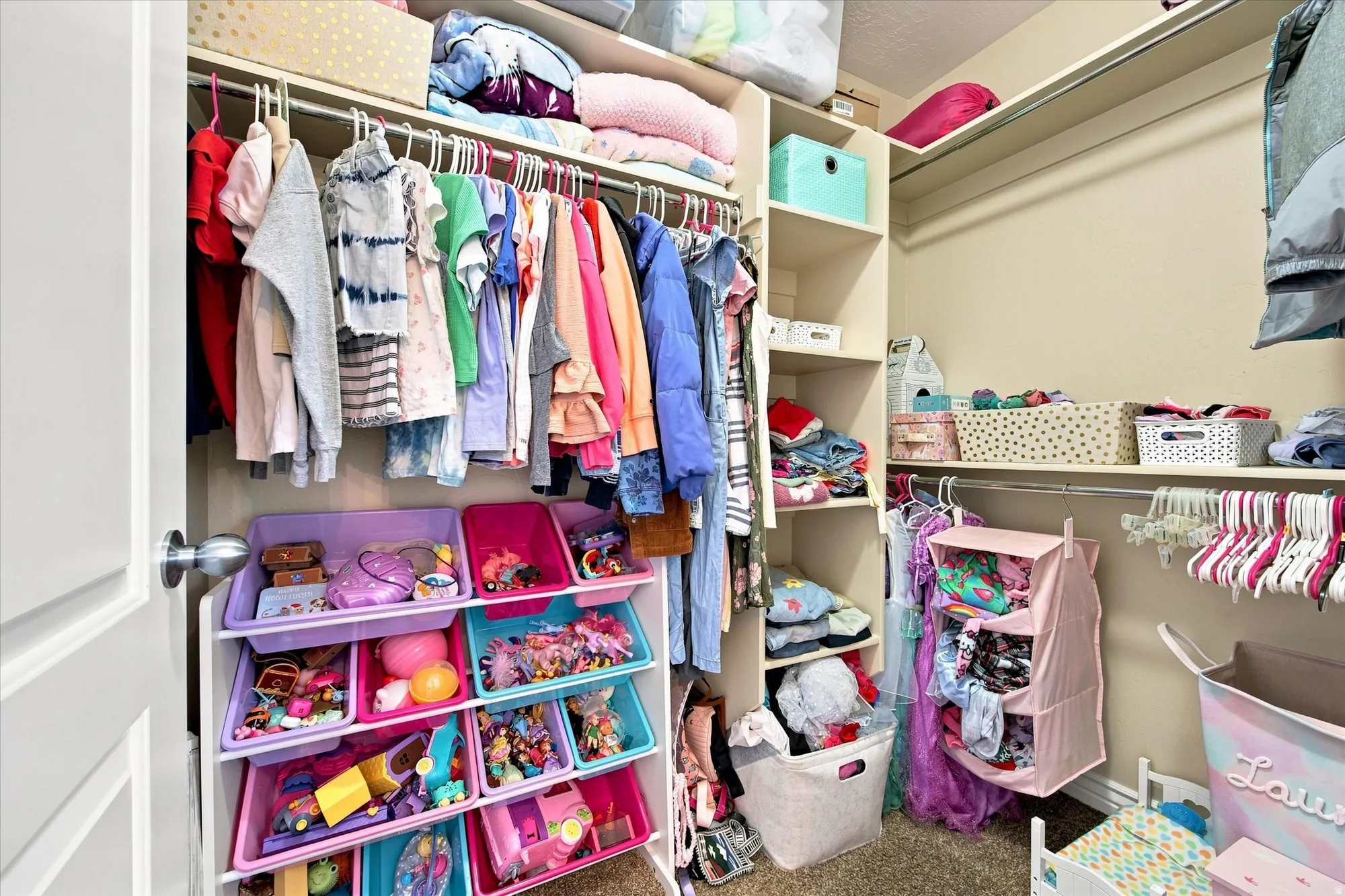 Walk in closet Integrated closet system with hanging rods and built-in shelving