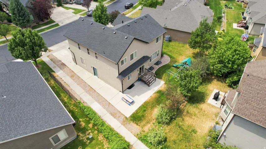 Two-story residence with a dark shingle roof and light-colored siding