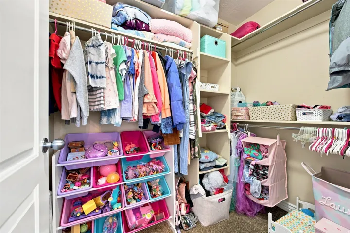 Walk in closet Integrated closet system with hanging rods and built-in shelving
