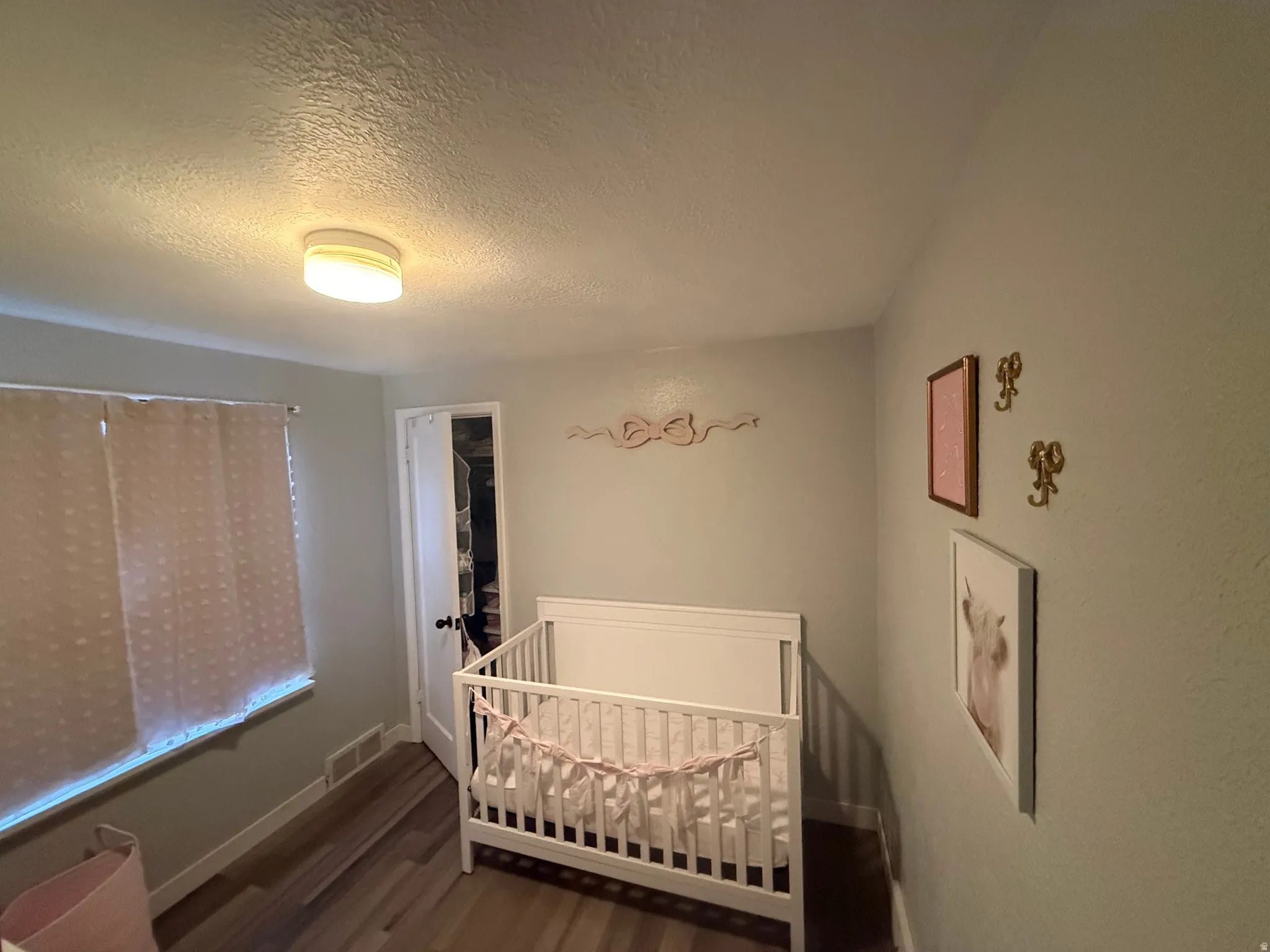 Recessed lighting, wood-finish flooring, and light-toned wall paint