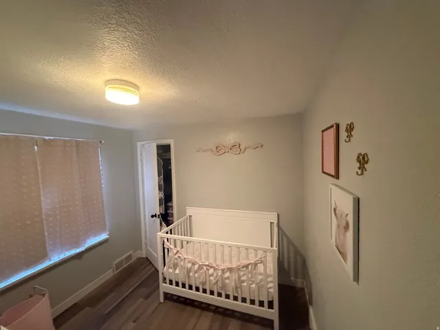 Recessed lighting, wood-finish flooring, and light-toned wall paint