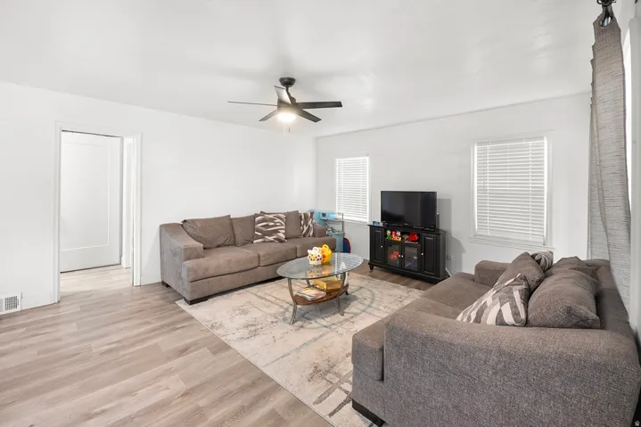 Recessed lighting, wood-finish flooring, and white walls