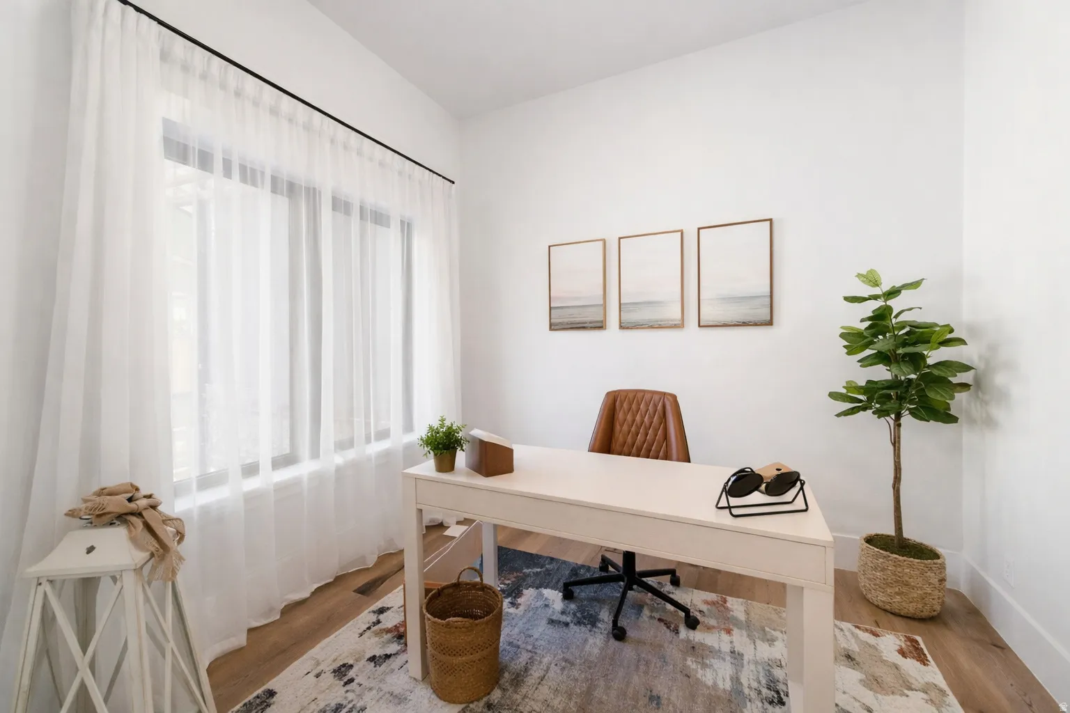 Hardwood flooring, expansive window with sheer white drapery, white walls, and recessed lighting