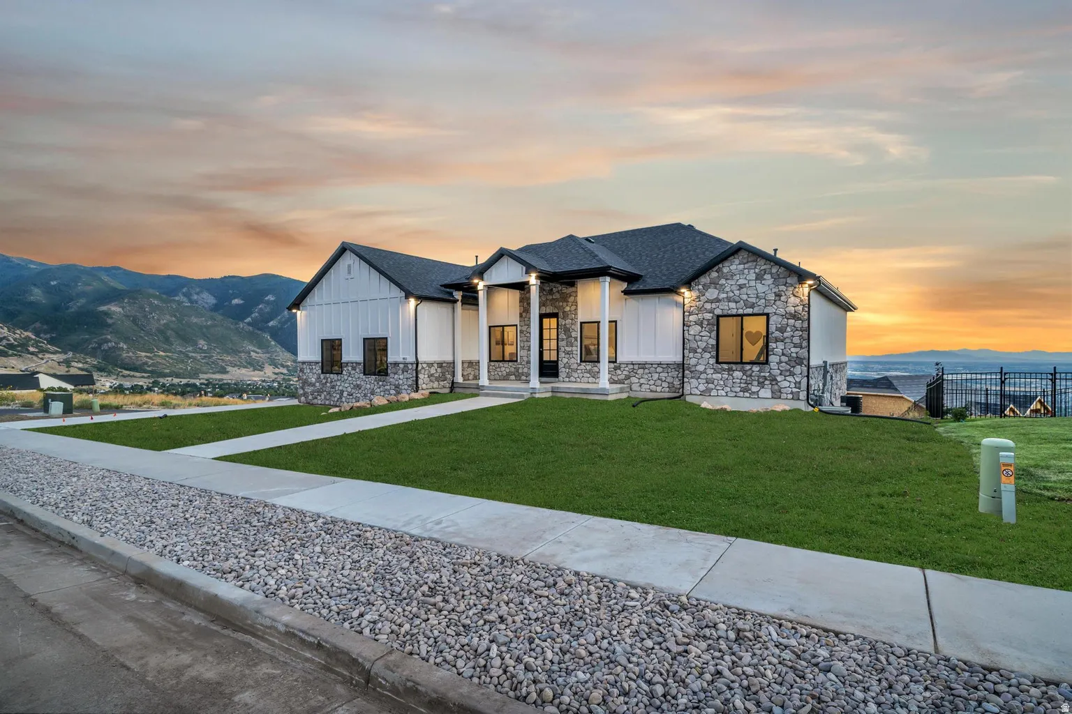 Modern farmhouse exterior featuring stone and vertical siding accents