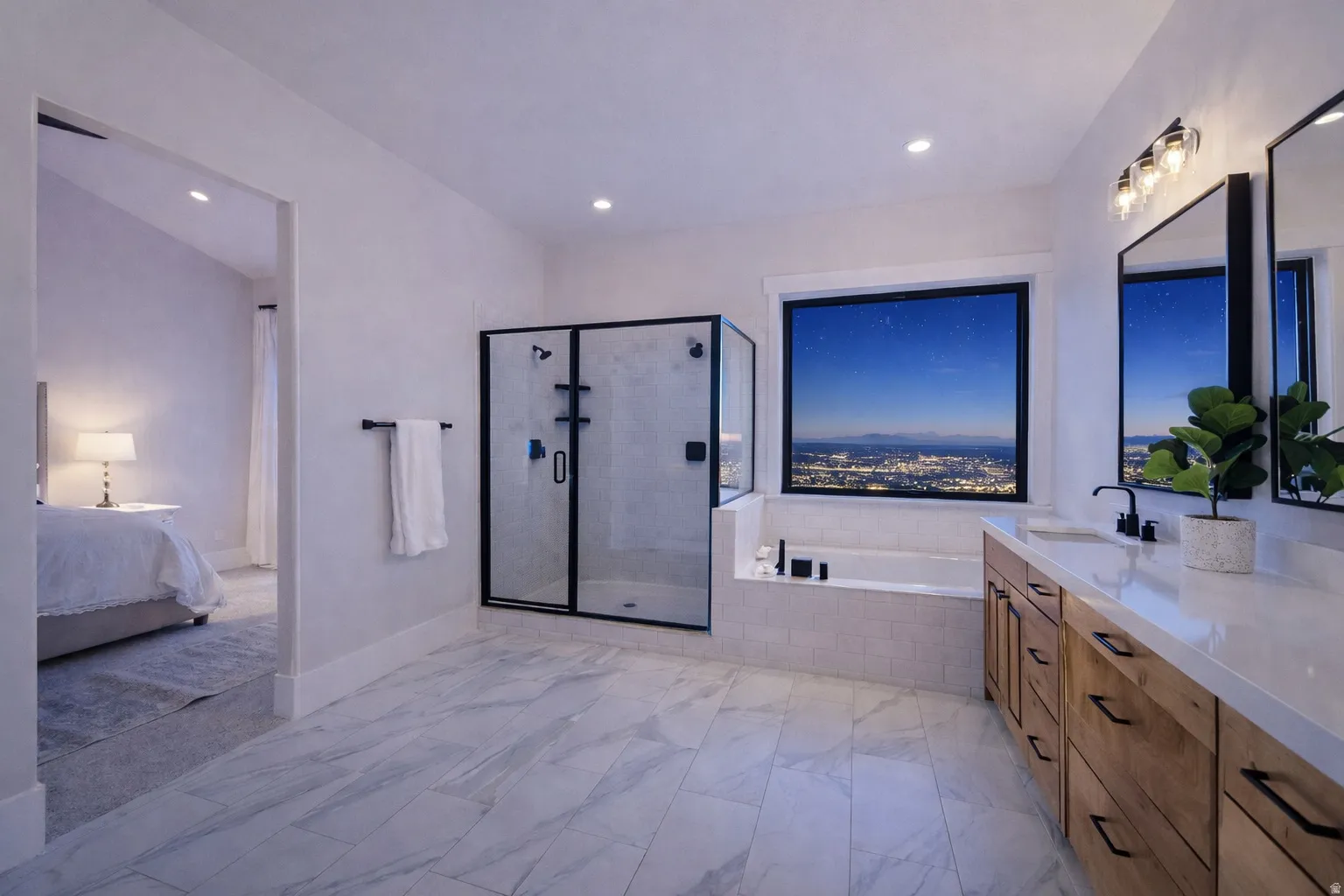 Spacious bathroom featuring marble-look tile flooring, a glass-enclosed shower, built-in soaking tub, and a double vanity with wood-finish cabinetry