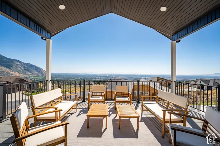 Covered outdoor deck with composite decking, recessed lighting, and metal railings