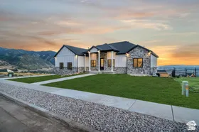 Modern ranch-style residence featuring stone and board-and-batten siding