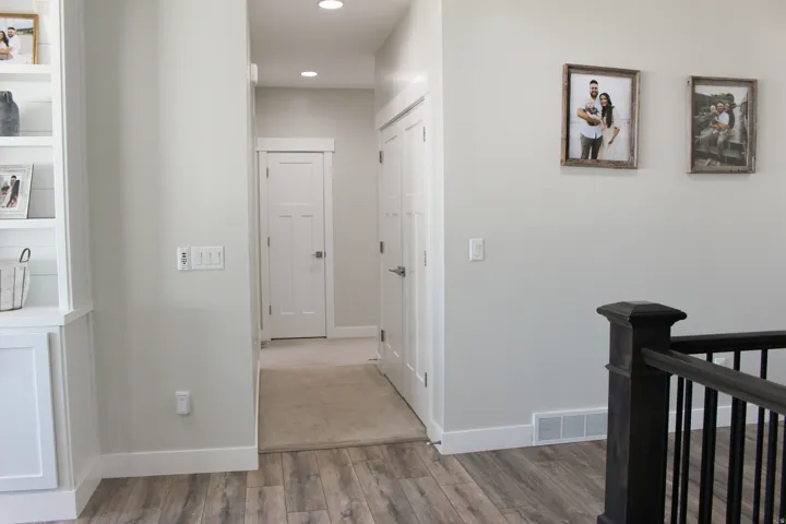 Wood-finish flooring with white baseboards