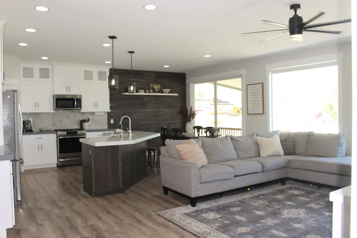 Open-concept living space featuring wood-finish flooring, recessed lighting, and a contemporary ceiling fan