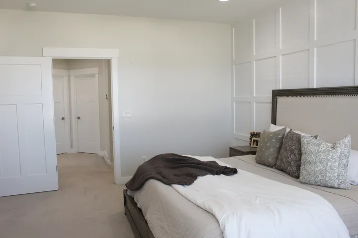 Recessed lighting, paneled accent wall, neutral wall color, white trim, and carpeted flooring