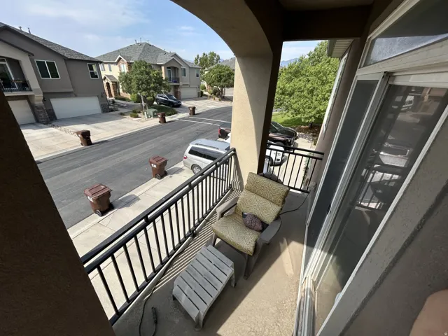 Balcony with black metal railings, concrete flooring West view.,
