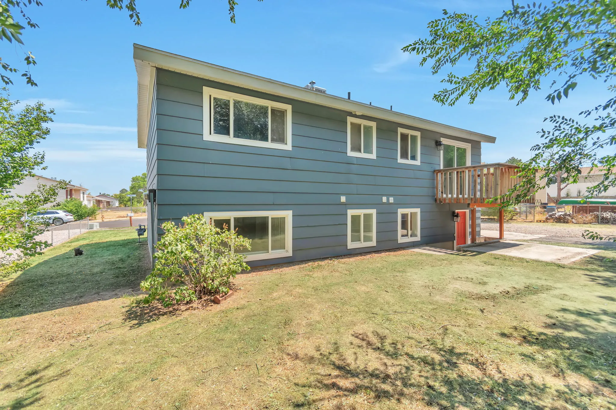 Blue siding exterior with white window frames