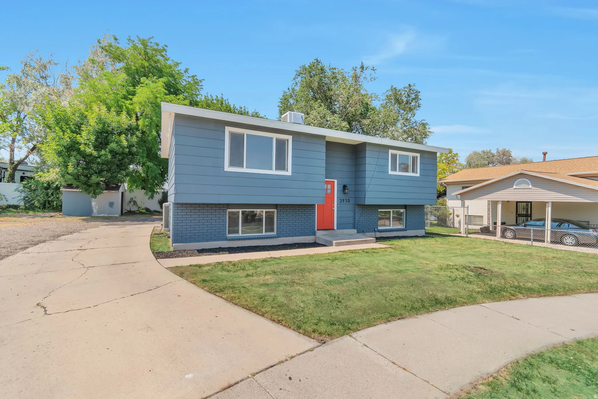 Split-level exterior with blue siding and dark brick accents