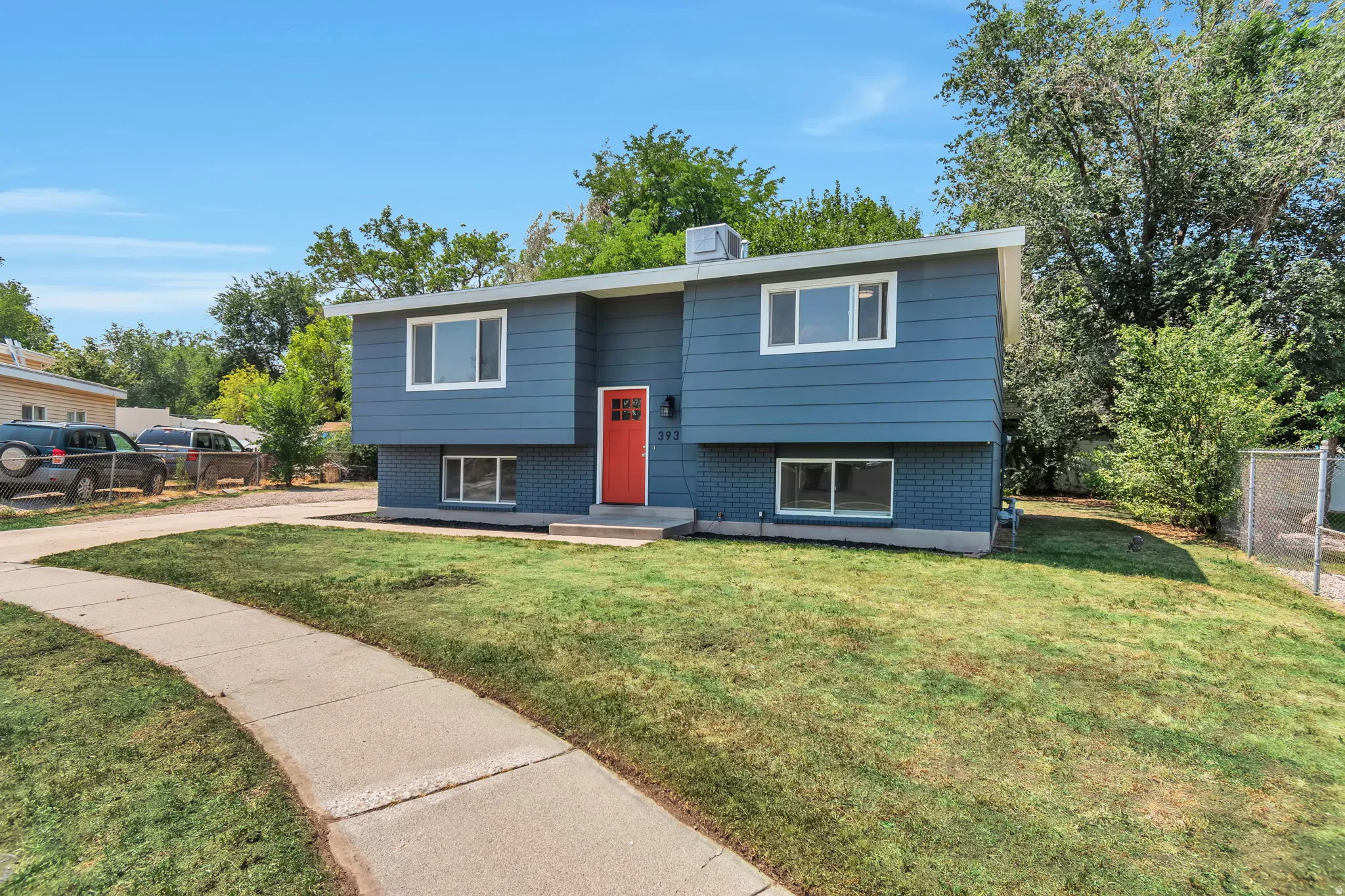 Blue exterior with horizontal siding and brick accents